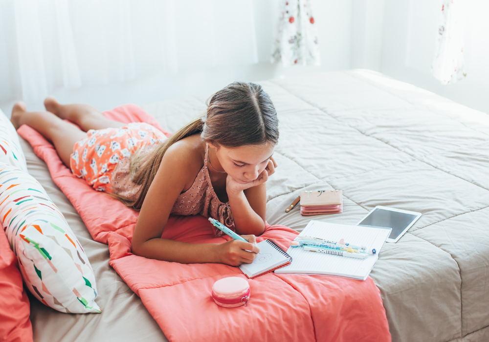 Girl respondin gto journal questions for teens. 