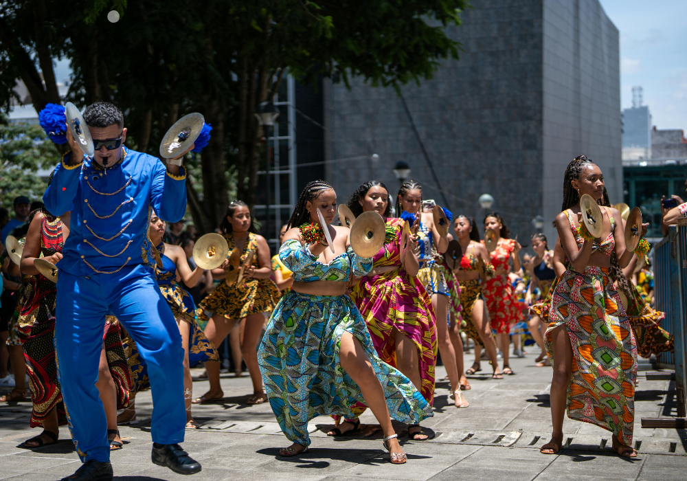 Costa Rica » WhatCherithInks People dressed in colorful clothes with instruments dancing in the streets in Costa Rica.