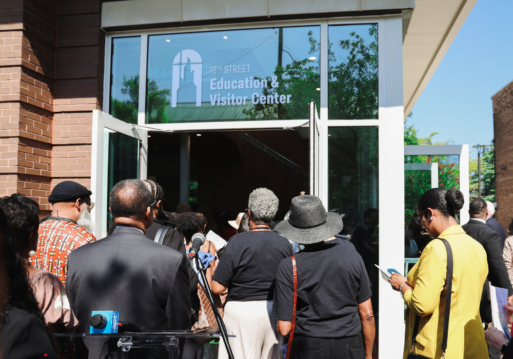 Several people heading inside the 16th Street Education & Visitor center to tour.