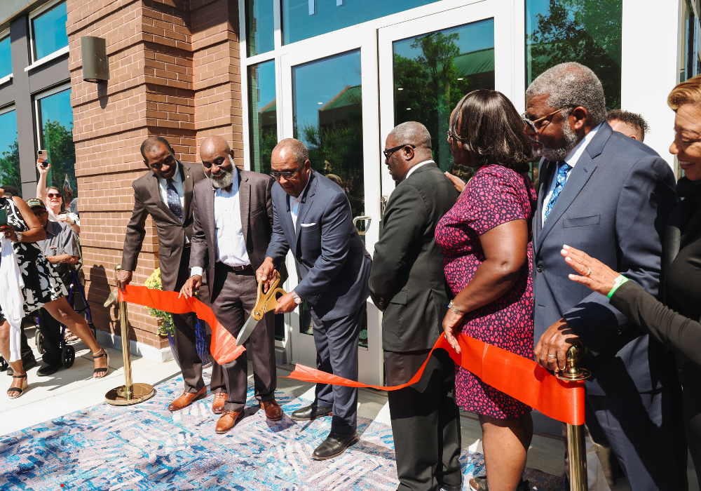 Group of people standing in front of the 16th Street Education and Visitor Center for the Ribbon Cutting.